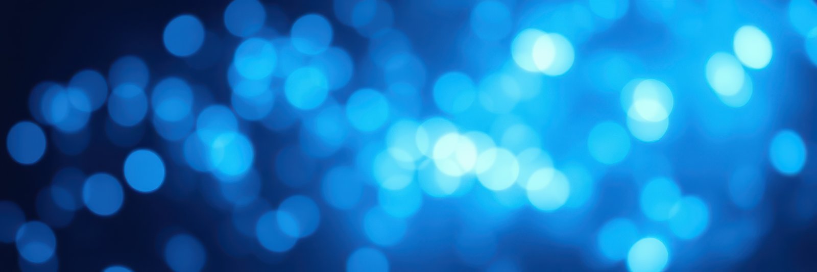 Bright blue bokeh lights create a dreamy atmosphere in an abstract setting during the night